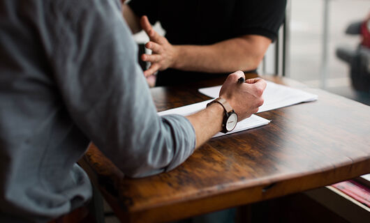 Individual Taking Notes during Meeting